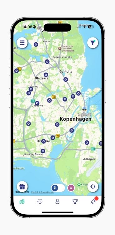 A smartphone shows the map view of petrol station locations in Copenhagen in the ryd app.