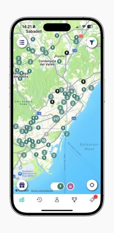 A smartphone shows the map view of charging station locations in Barcelona in the ryd app.